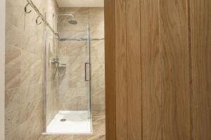 a bathroom with a shower with a glass door at The Stables in Grewelthorpe +27 photos