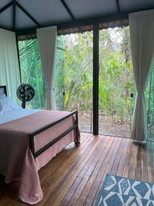 a bedroom with a bed on a wooden deck at Céu da Terra in Colinas Do Sul