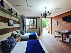 a hotel room with two beds and a desk at La Luna @ Misty Mountains in Studholme