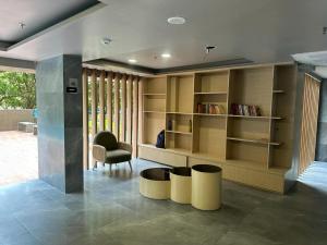 a living room with a book shelf and a chair at Residential Tranquil in Mumbai