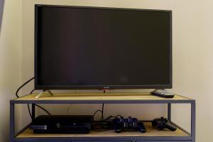 A television and/or entertainment centre at Felt in love in Catania