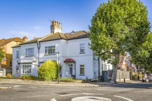 a white house on the corner of a street at London Calling 3 bed 3 baths 5 mins from train into City in Winchmore Hill