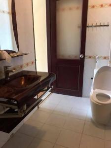 a bathroom with a sink and a toilet at Đinh Gia Palace in Nam Giao
