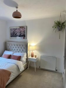 a bedroom with a bed and a table with a lamp at 3 double bedroom spacious flat in Largs