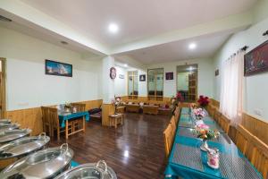 a dining room with tables and chairs and a room with at Leh Stumpa in Leh