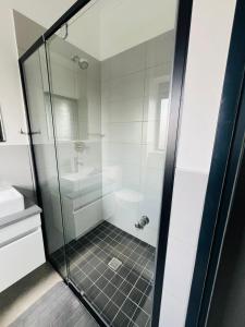 a bathroom with a shower with a glass door at Comfort in the Heart of Waterfall in Kyalami