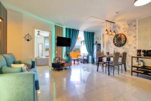 a living room with a couch and a table at LUXORY DREAMY SUNSET, SeaFront, Direct Access To The Promenade,Wifi,Pool,Free Parking in Los Cristianos
