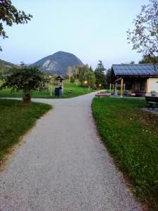a gravel path in a park with a building at A Casa mia in Bieno +17 photos