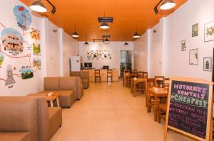 a dining room with tables and chairs and a sign at Nhi's House & Safari -Motorbike Rental-Tour in Ha Giang
