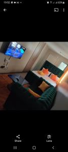 een foto van een kamer met een bed en een tv bij Jessy stays in Nairobi