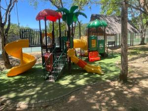 a playground with a slide and a play structure at DUBE SAFARI LODGE at Kruger Park Lodge 505 in Hazyview