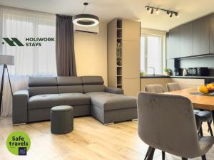 a living room with a couch and a table at 2BR Business Suite with FREE GYM, by Holiwork Stays in Plovdiv