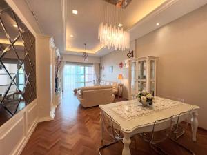 a living room with a table and a couch at Luxury Seaview Family Suite at Straits Quay in Tanjong Tokong