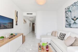 Biały salon z białą kanapą i stołem w obiekcie Beach Apartment Playa del Cura 4 w mieście Playa del Cura