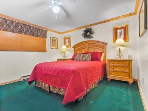 a bedroom with a bed with a red comforter at ML286 Beautiful Views New Deck WiFi EZ Parking in Snowshoe