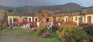 a house with a table and chairs in a yard at Cabañas Rincon Austral in Puerto Montt