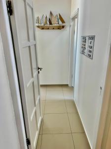 a hallway with an open door and a tile floor at Ocean Dream Sunset Sails in Swakopmund +87 photos