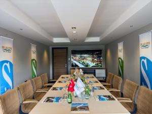 a conference room with a long table with chairs and a tv at Sera Lake Center Hotel in Trabzon +101 photos