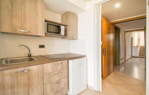 a kitchen with a sink and a microwave at Mono 2 in Lido di Mondello