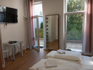 a hotel room with two beds and a mirror at Mirabella 1 in Kołobrzeg