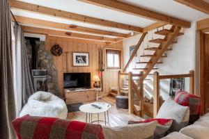 a living room with a staircase in a cabin at La Bastide - Grand chalet privé - Quartier calme in Les Houches
