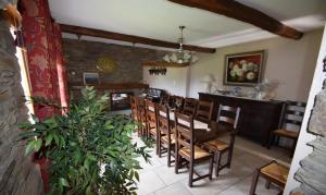a dining room with a wooden table and chairs at La Petite Ferme in Rochehaut