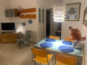 a dining room with a blue table and chairs at IL Quieto Uliveto in Ostuni