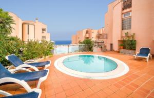 a swimming pool in a patio with two chairs at Bilo 4 in Lido di Mondello +22 photos