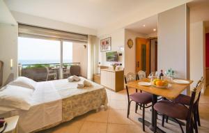 a bedroom with a bed and a table and a dining room at Bilo 4 in Lido di Mondello