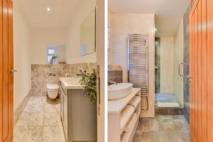 a bathroom with a sink and a toilet and a shower at The Hideaway @ Flagham Cottage. in Malmesbury +54 photos