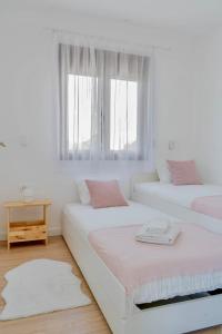 two beds in a white room with a window at Rent a NEST in Arandelovac +33 photos