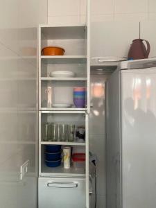 a refrigerator with its door open in a kitchen at Ap praia Bertioga cm garagem in Ilha Monte Pascoal +9 photos