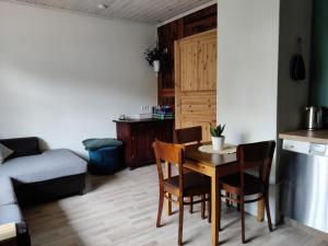 a kitchen and living room with a table and chairs at Suure terrassiga korter raudteejaama lähedal in Viljandi