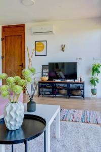 a living room with a table and a tv at Rent a NEST in Arandelovac