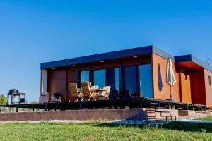 a house with a table and chairs in front of it at Rent a NEST in Arandelovac