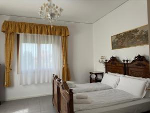 a bedroom with a bed and a window at Venetian Mood: Secret Garden in Venice