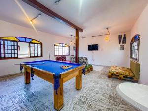 a living room with a pool table in it at Pousada Yurgs in Caraguatatuba