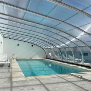 a swimming pool with a glass ceiling at Quequen Casa las Olas frente al mar 4 pax in Quequén