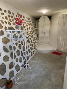 a bathroom with a shower with a stone wall at Villa Kingdome - 1 Bedroom in Teluk Nara +29 photos