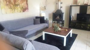 a living room with a couch and a coffee table at Garden House in Amarynthos