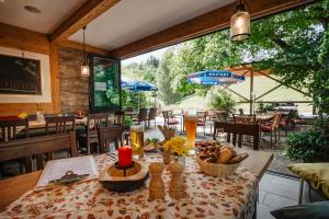 a dining room with a table with food on it at Landhotel Neuhof in Zenting