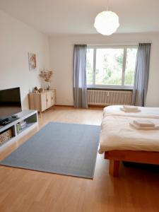 a bedroom with a bed and a large window at Gemütliche Wohnung Nähe Uni in Basel