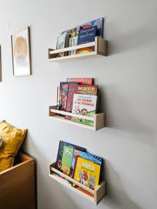 a bunch of books are on a wall at Apartament F&M in Braga +14 photos