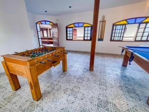 a room with a pool table and ping pong tables at Pousada Yurgs in Caraguatatuba +16 photos