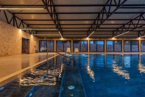 a swimming pool with blue water in a building at Premium mobile home FJAKA - Oaza Mira Camping Croatia in Drage