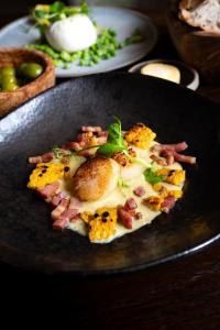 a plate of food on a table with food at Charingworth Manor in Chipping Campden