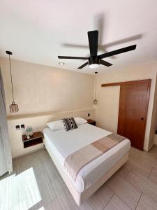 Postel nebo postele na pokoji v ubytování Hotel Caracol Isla Mujeres