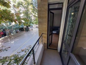 a balcony of a building with a door and a street at Sky Hills 2 Apartment in Sandanski