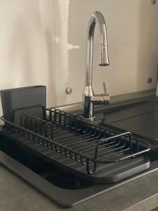 a metal sink with a faucet in a kitchen at Appartamenti ModeRna - Relax e stile a due passi dal Duomo in Modena