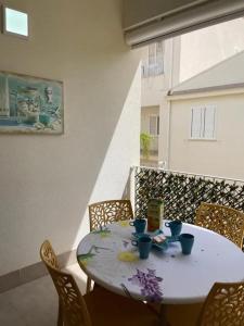 a white table with chairs on a balcony at Spacious Apartment in Balestrate 70 m² with Balcony in Balestrate